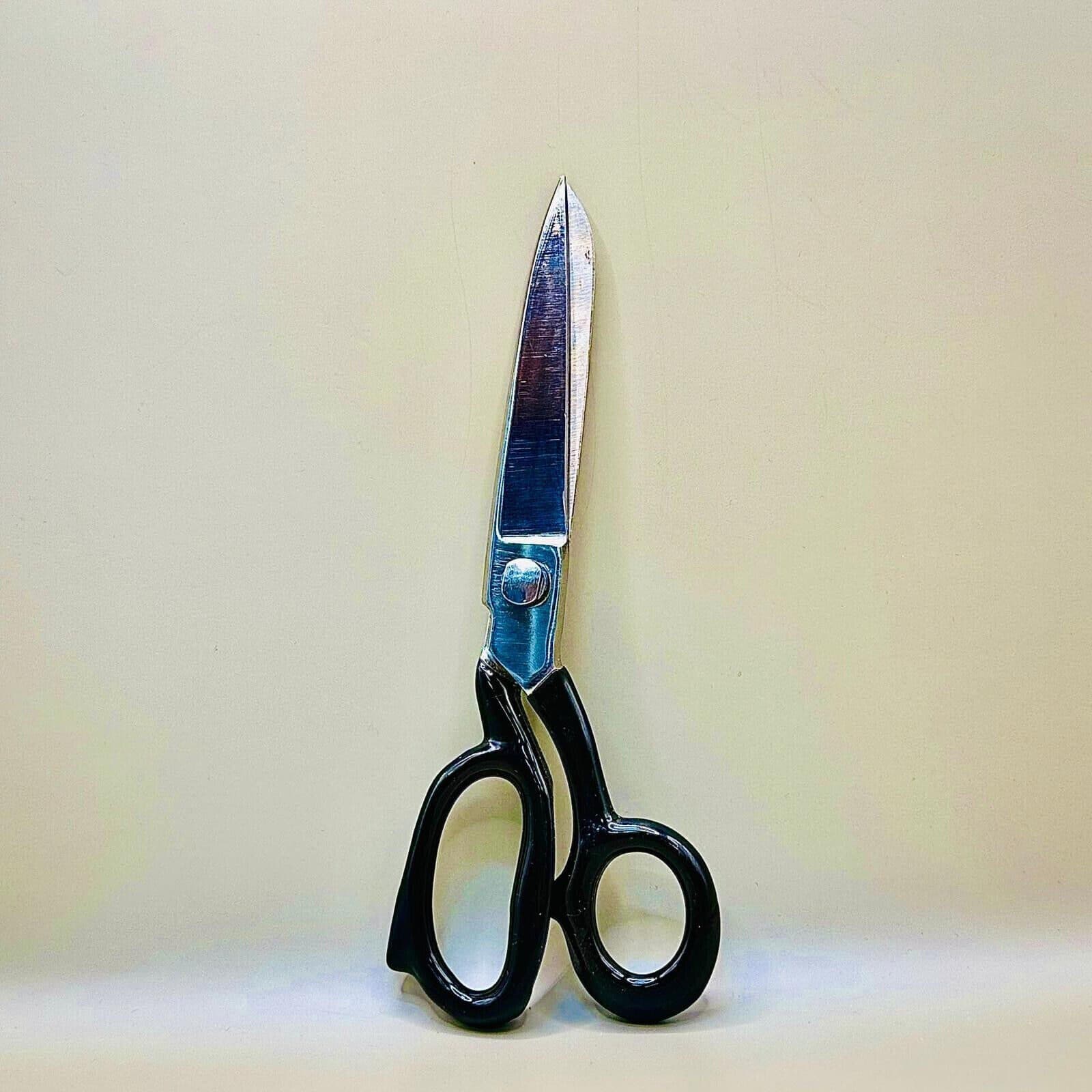 Close-up of sharp stainless steel blades on 12 inch tailoring scissors.